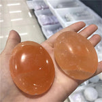 Orange selenite palm stone