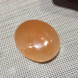 Orange tumbled selenite stone